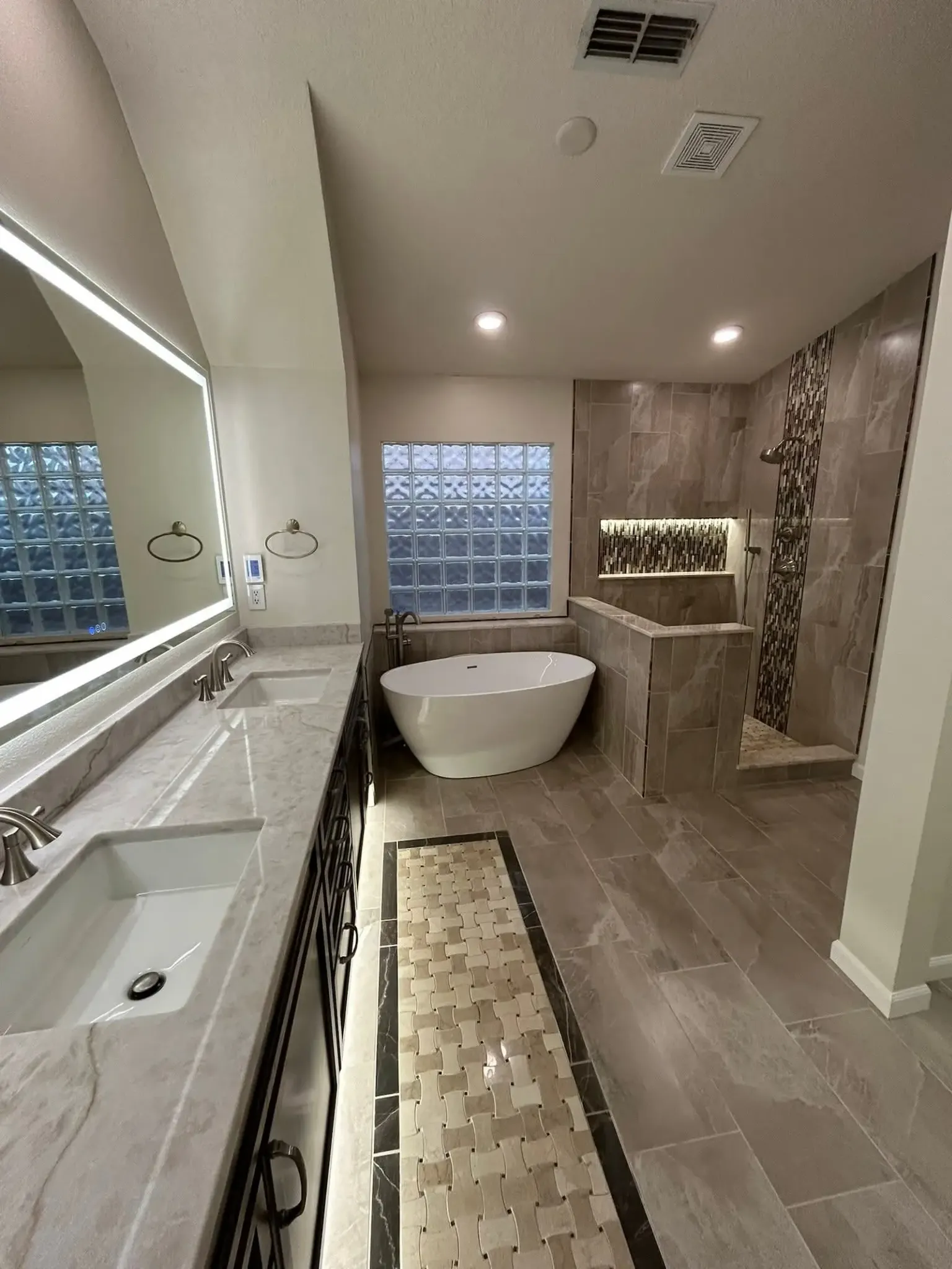 Completed bathroom surface updates with tile, bathtub, and vanity in Sarasota