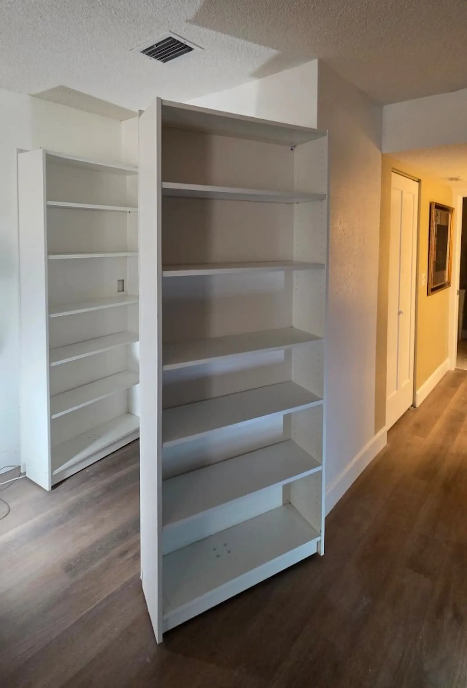 White custom shelving unit being installed in a closet alcove in Bradenton