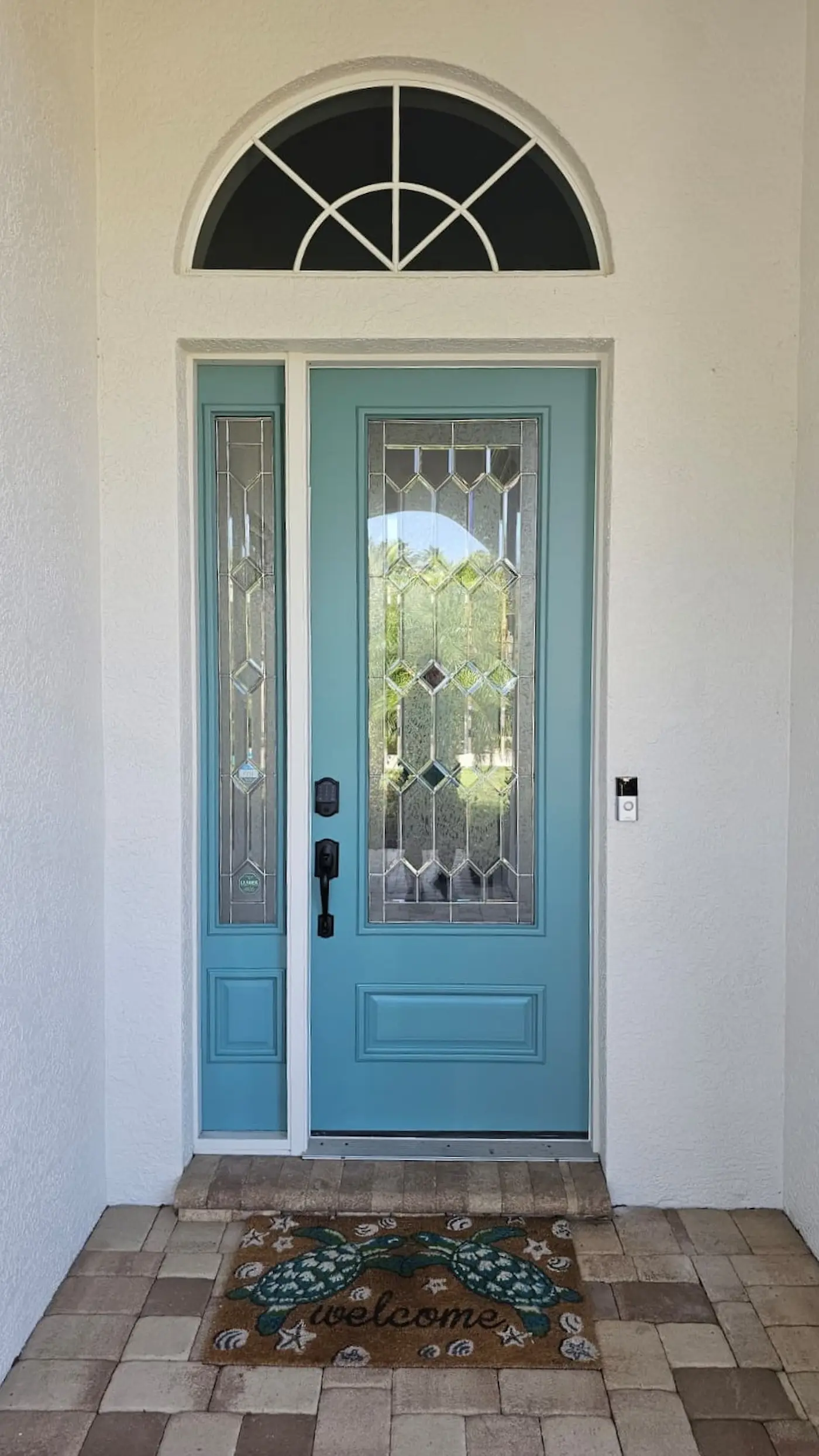 Completed front entry door restoration with new finish and hardware in Sarasota, Florida.
