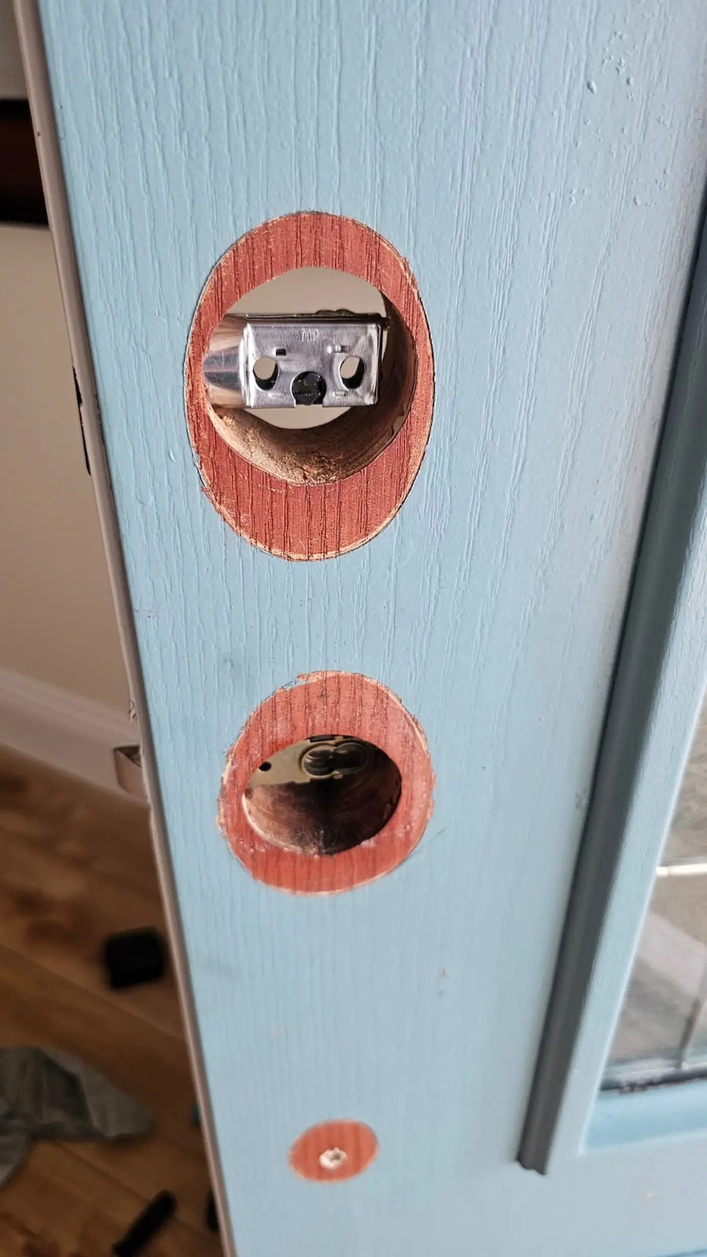 Front entry door prepared for new hardware installation during a door restoration project in Sarasota, Florida.