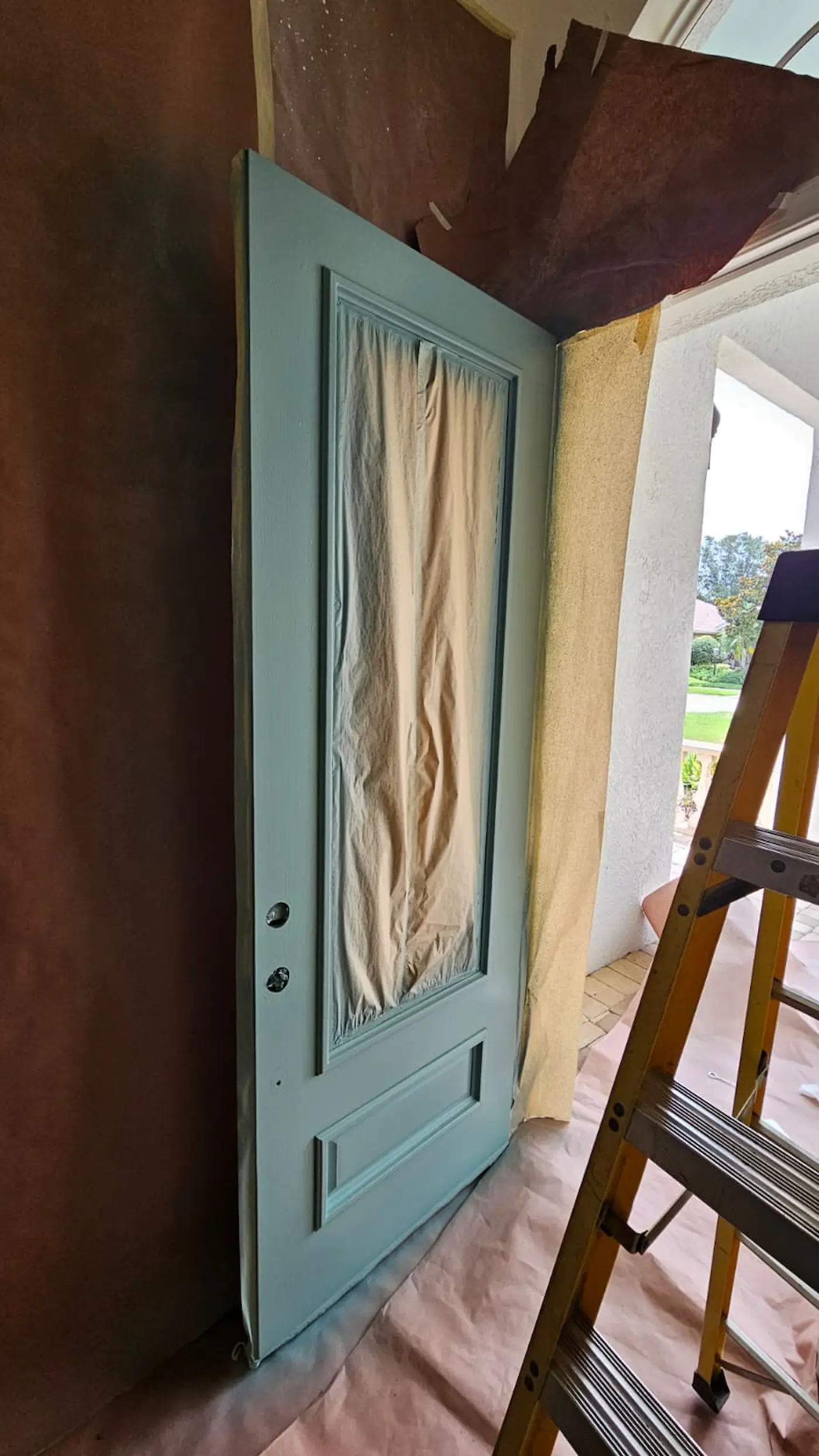 Freshly refinished front entry door before final hardware installation in Sarasota, Florida.