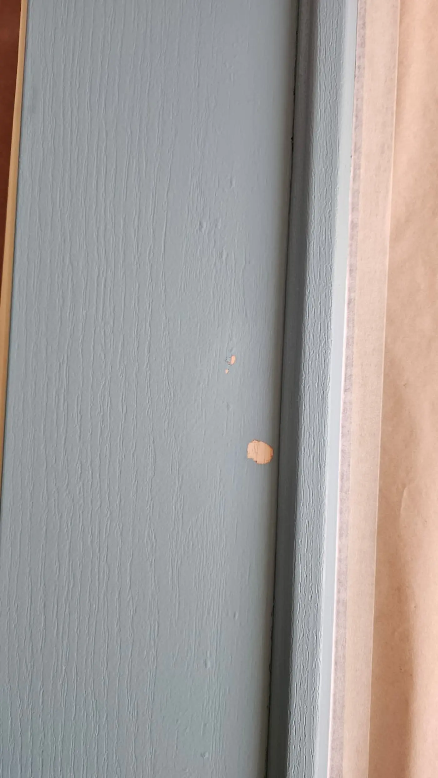 Surface preparation on a front entry door before refinishing and painting in Sarasota, Florida.