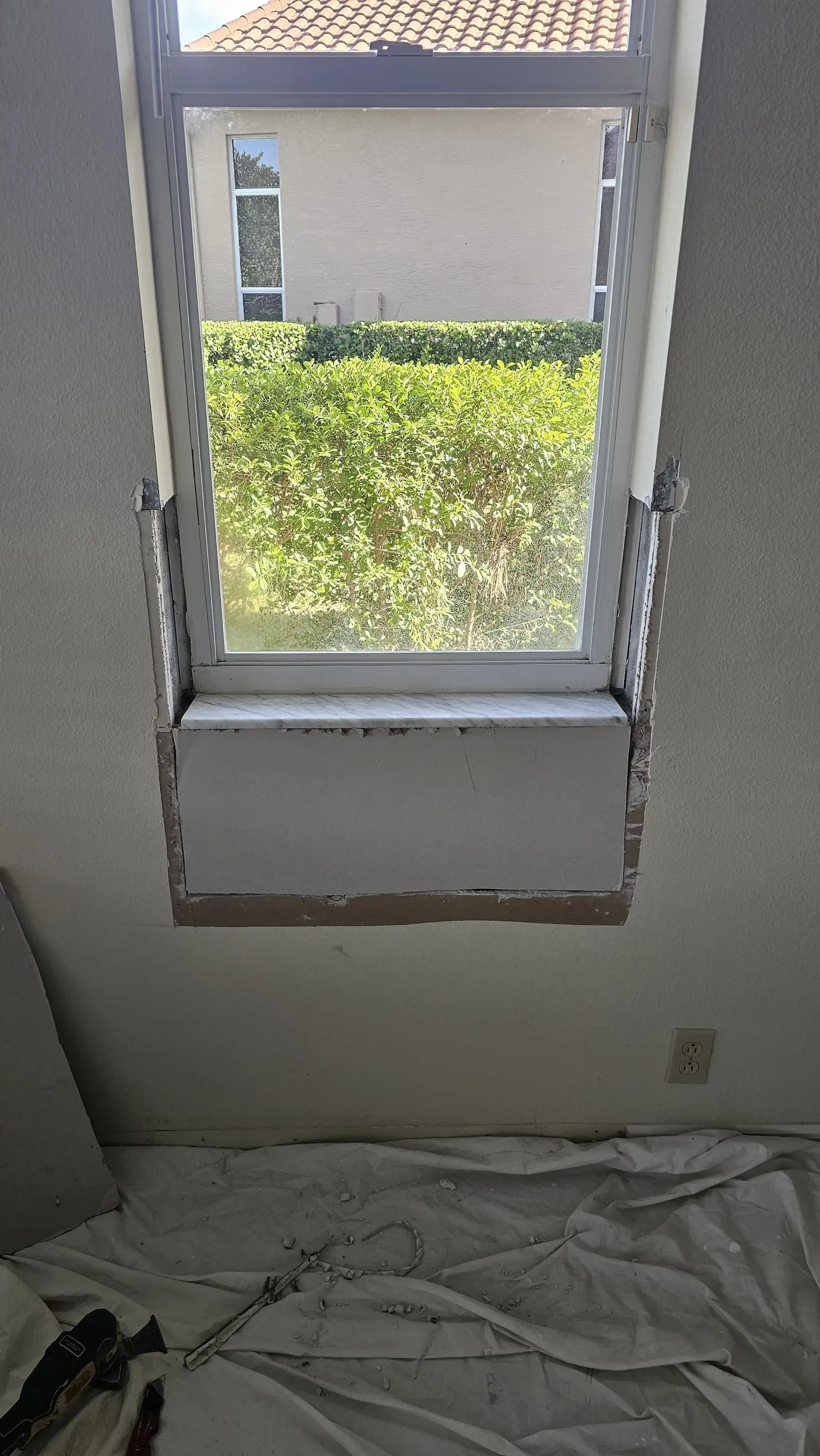 Window repair during drywall reconstruction and trim installation.