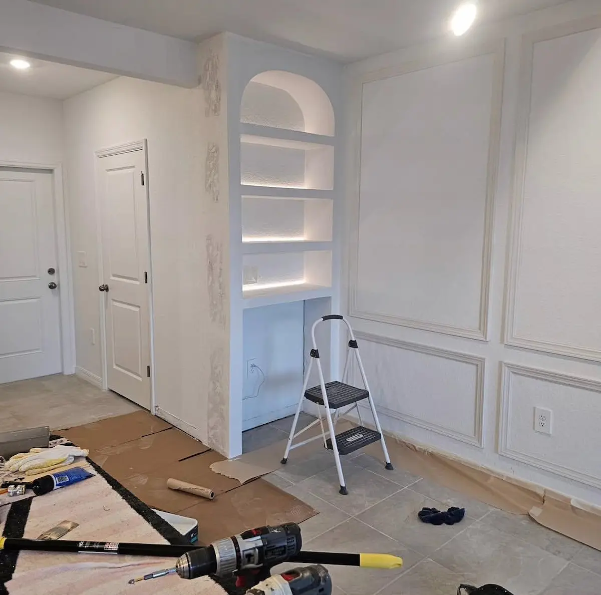 Living room interior updates with custom wall features under construction